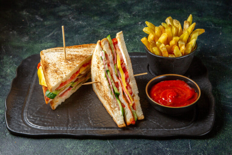 front view tasty ham sandwiches with french fries dark surface